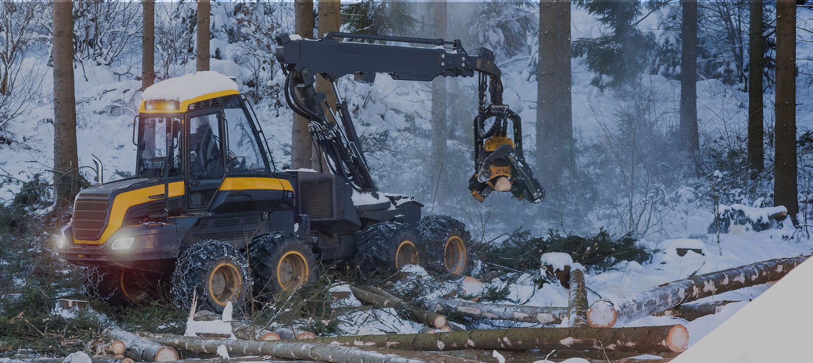 Forestry machine in snow-covered forest