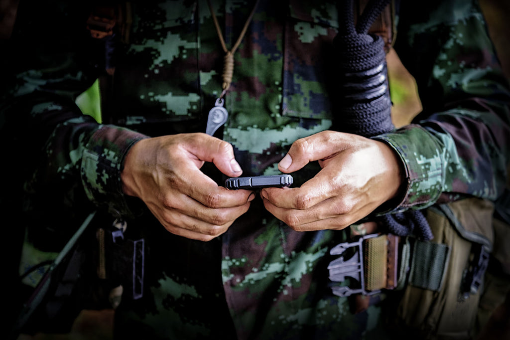 Soldier using cell phone to navigate