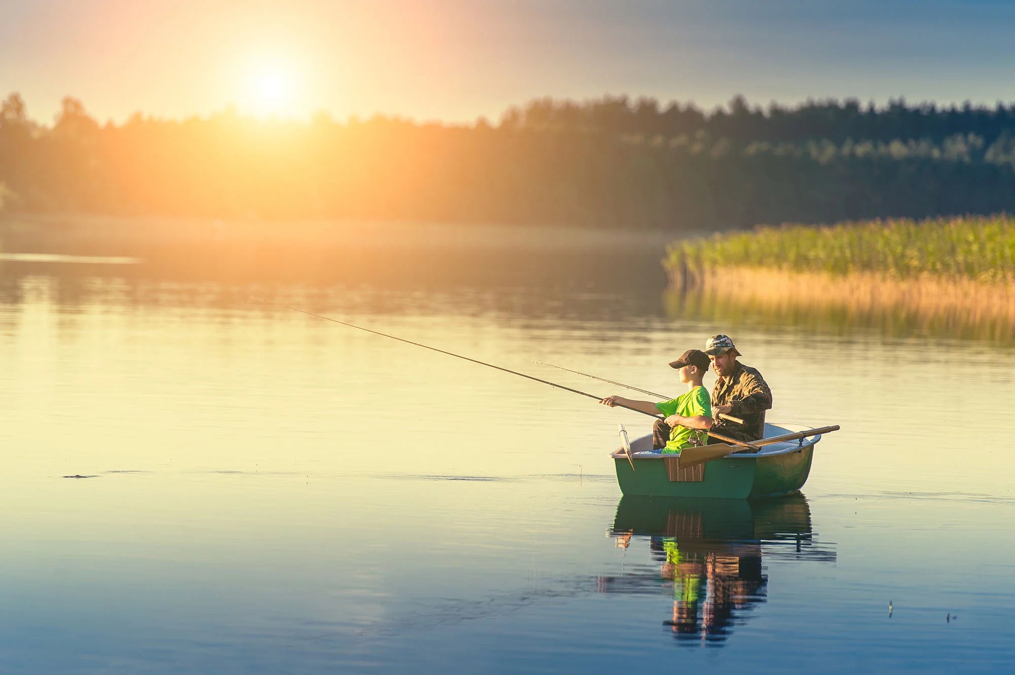 Father and son fishing on a boat in a lake