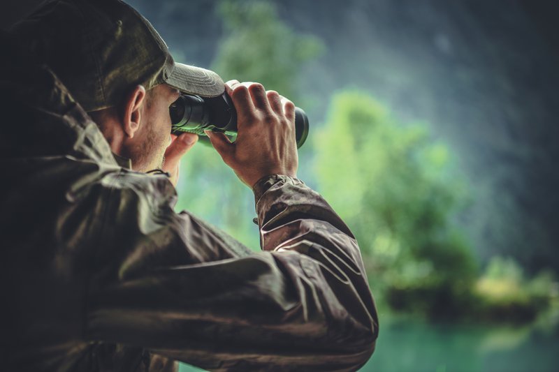 Man hunting with binoculars