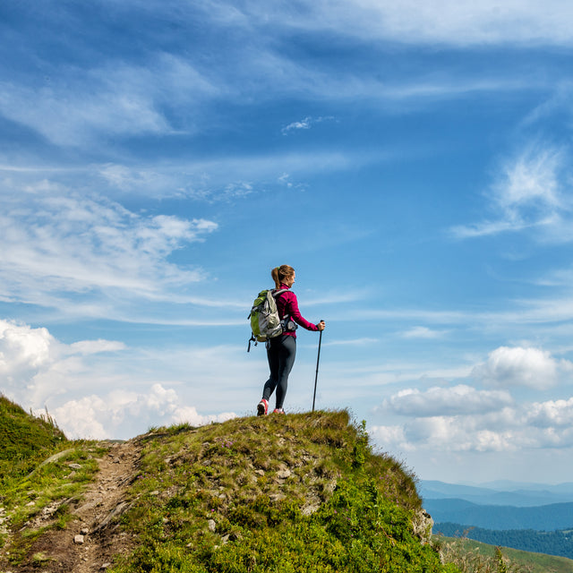  Young woman hiking in the mountains 