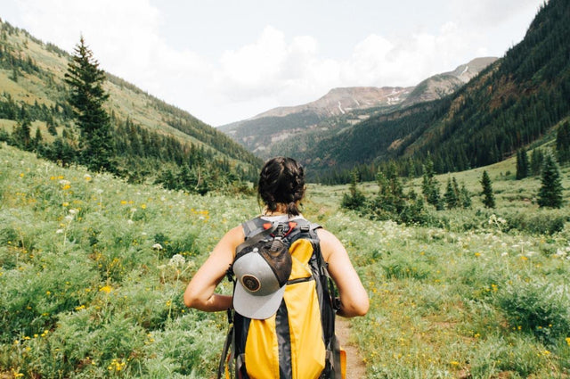 Woman hiking with yellow backpack