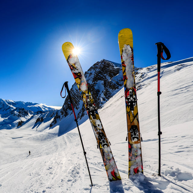 Ski in winter season, mountains and ski touring equipments on the top in sunny day 