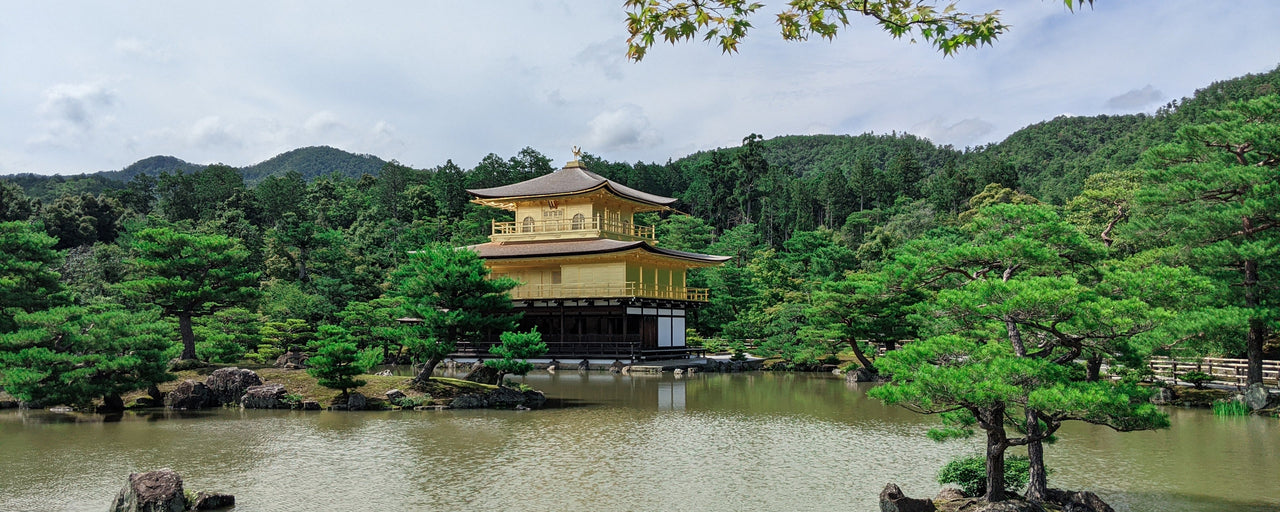 View of trees, lake and a traditional Japanese house in Kyoto