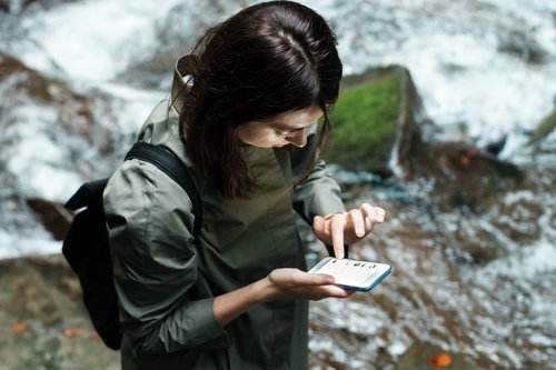 Girl using Avenza Maps on a hike