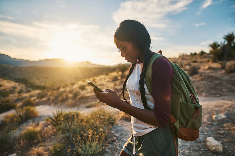 Woman using digital map on her cell phone