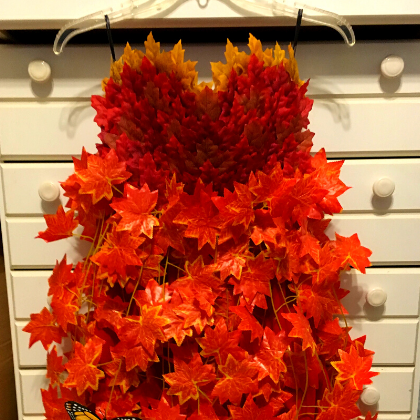 Dress made up of red and orange leaves