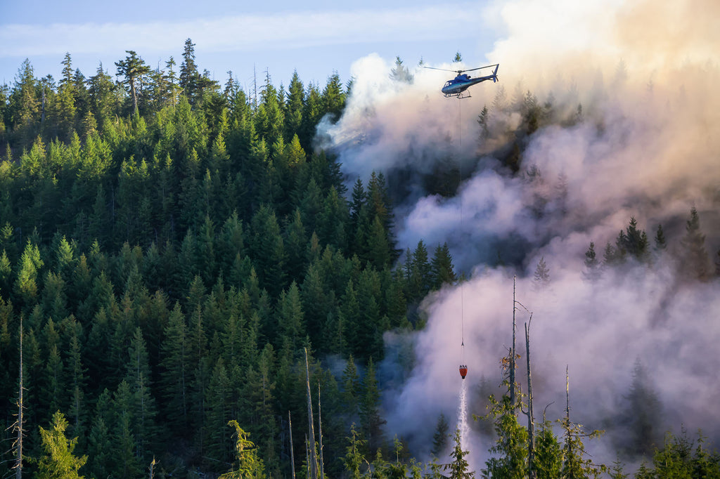 Rescue helicopter flying over forest fire