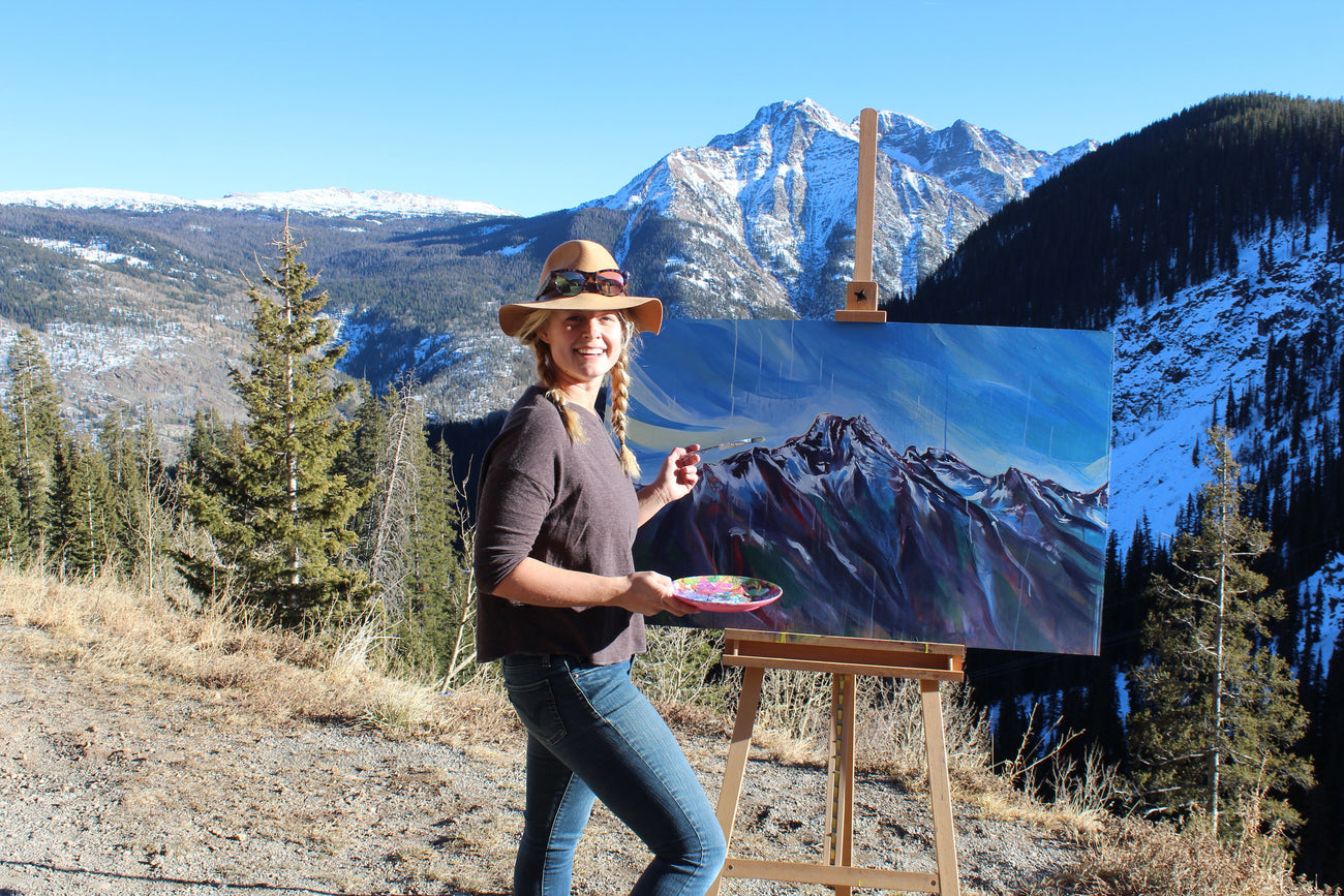 Hannah Wilson painting in the mountains