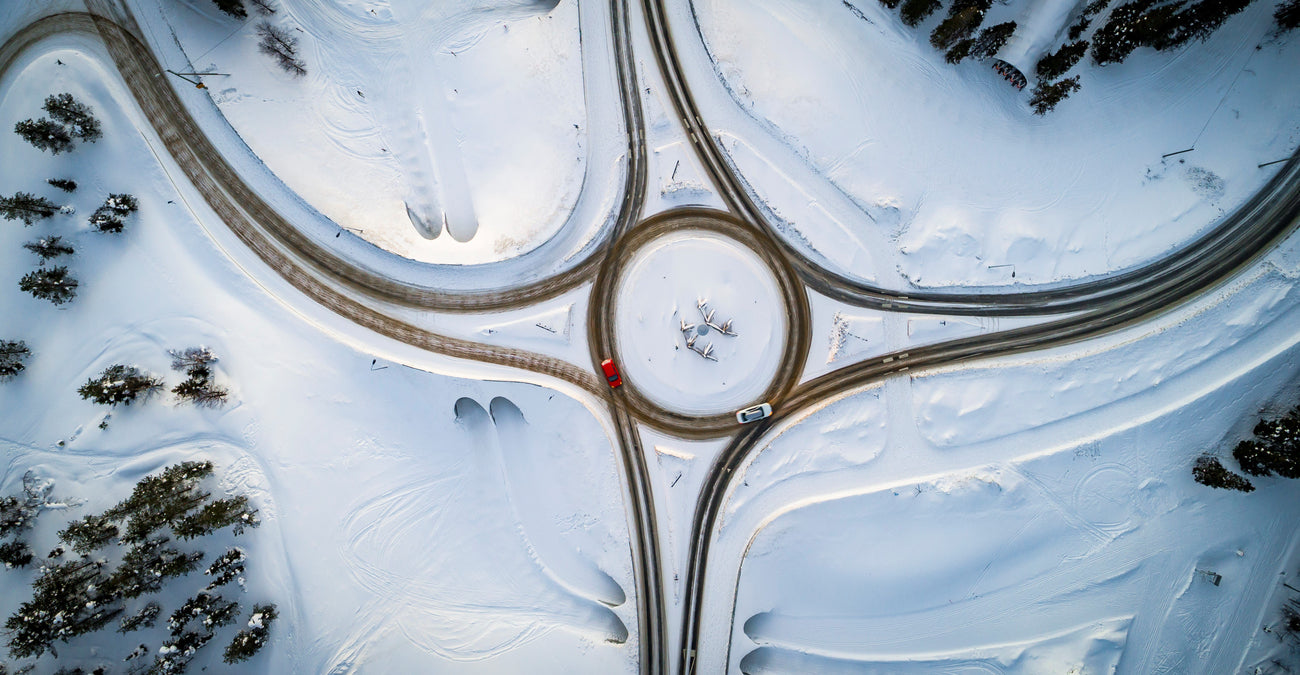 Aerial map of cars driving on snowy road