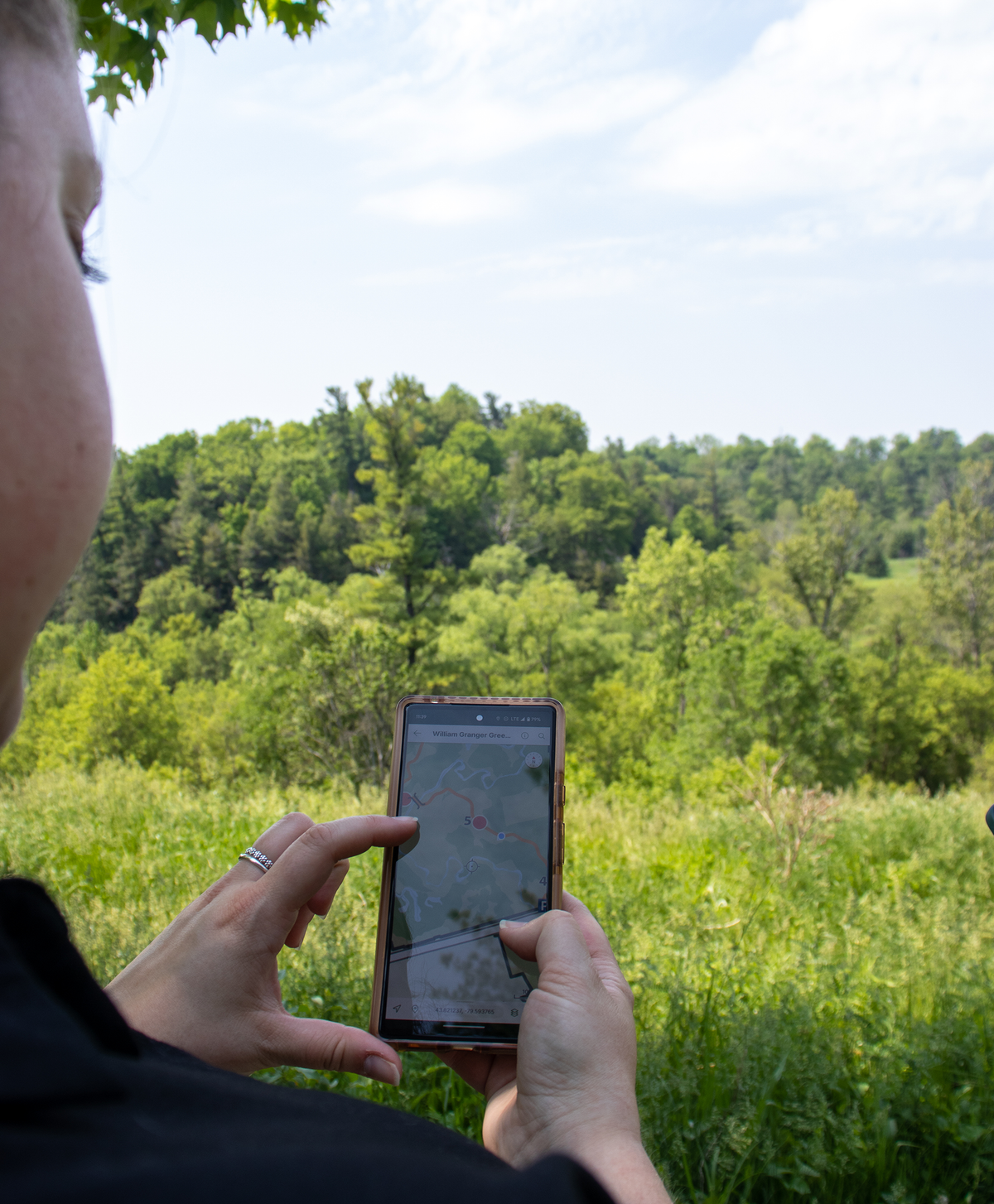 Woman looking at map in Avenza Maps on her phone