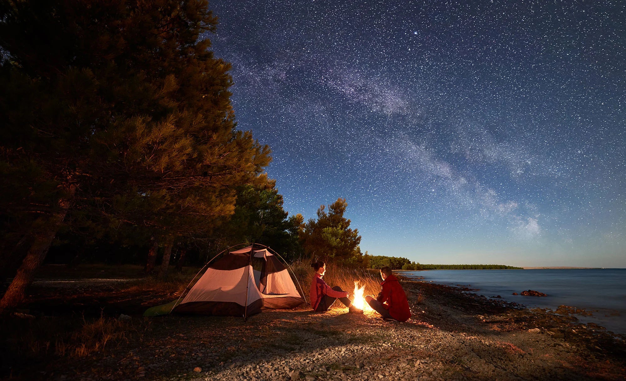 Two people camping under the stars