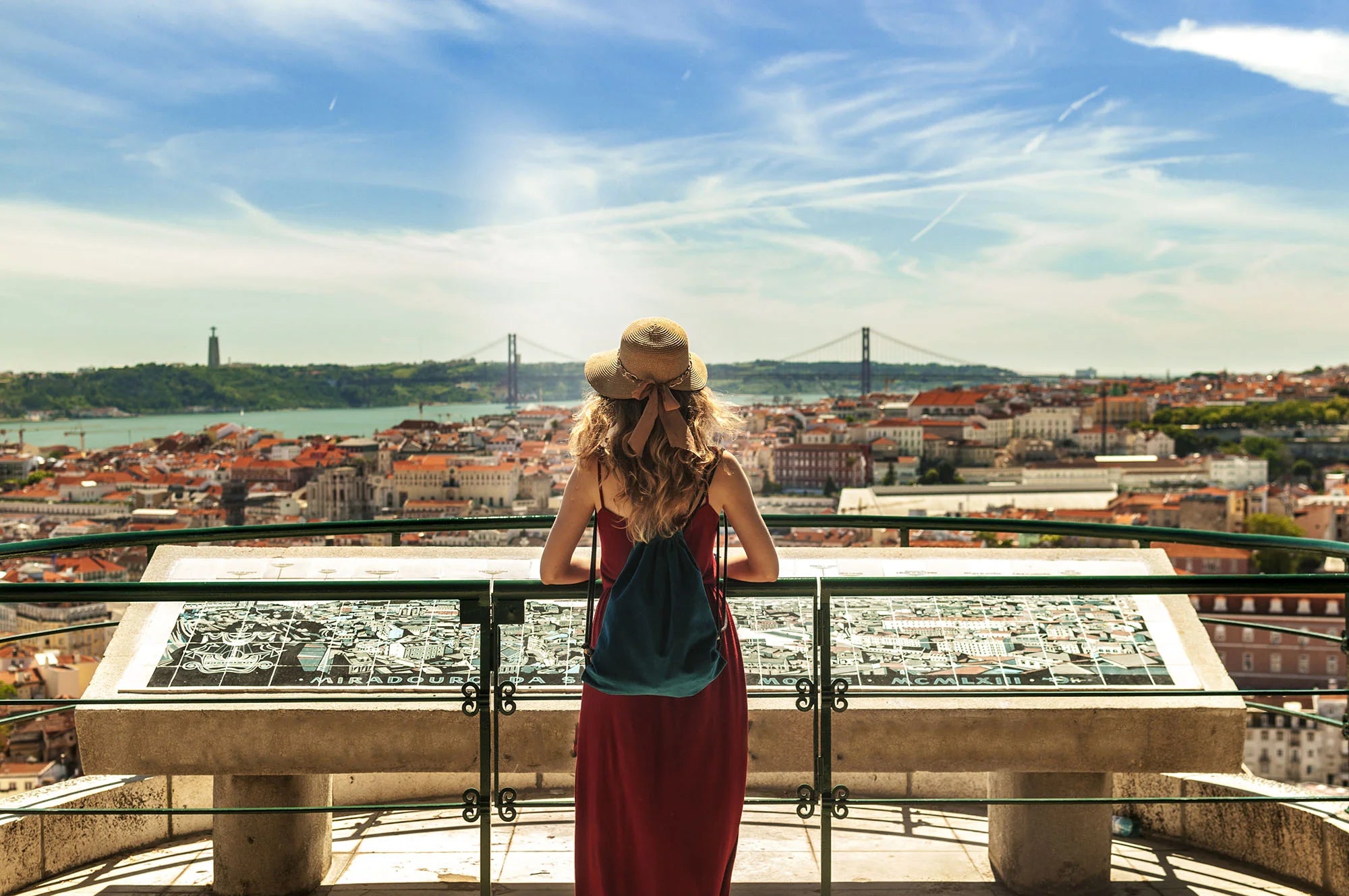 Tourist looking over the city of Lisbon from a viewpoint