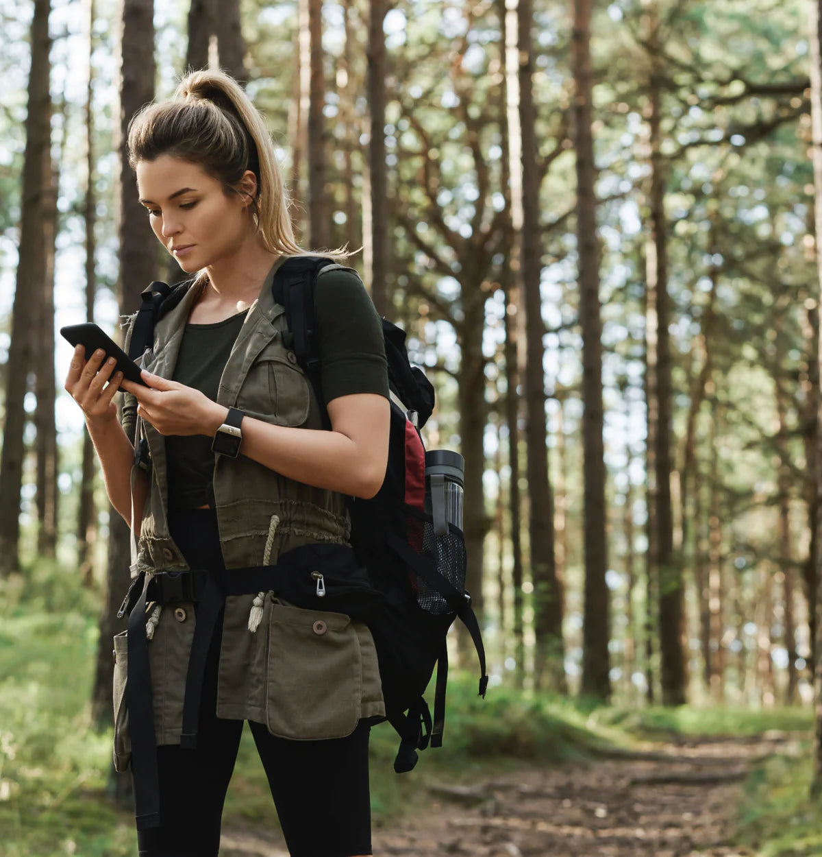 Woman checking her phone while hiking