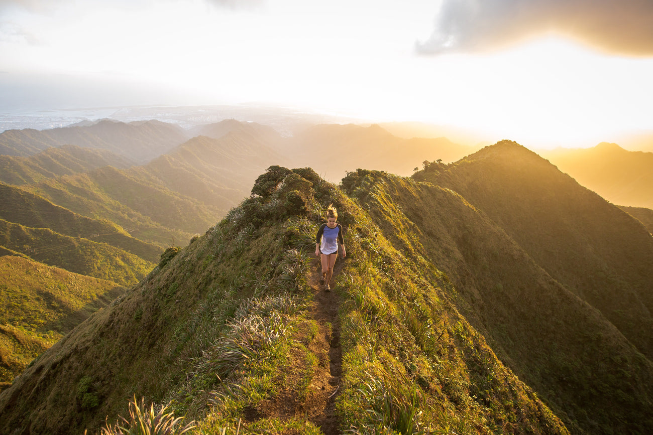 Girl walking down a mountain trail