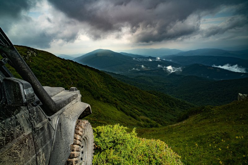 Offroading vehicle overlooking mountains