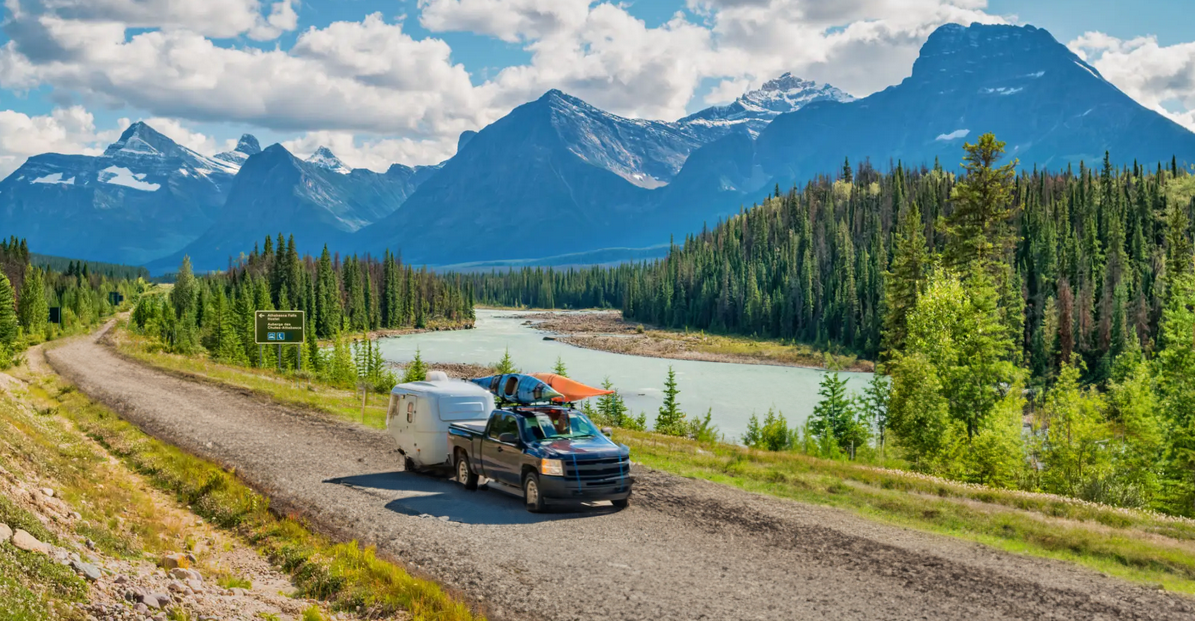 Car on the road with the views of river and mountains