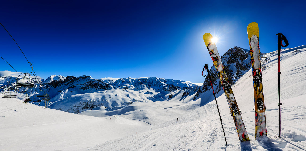 Ski in winter season, mountains and ski equipments on a sunny day 