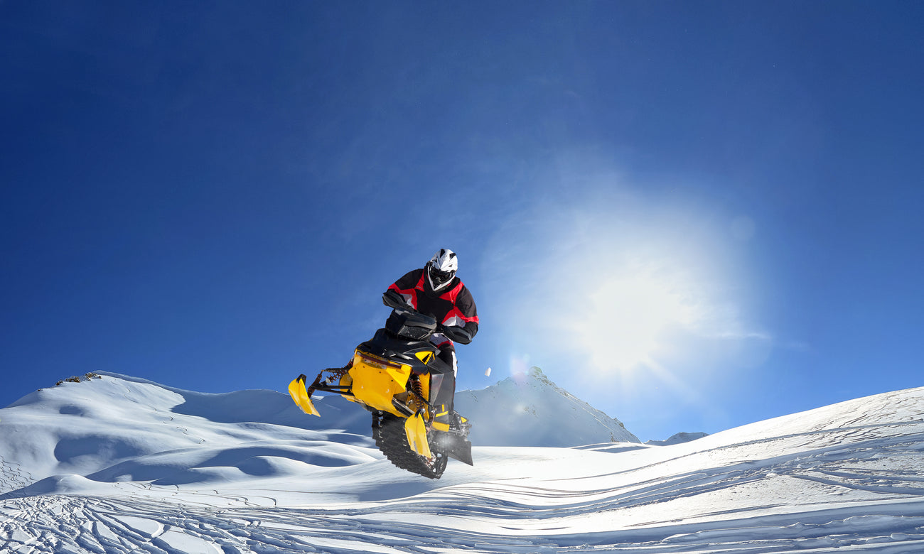 Snowmobiler doing a jump